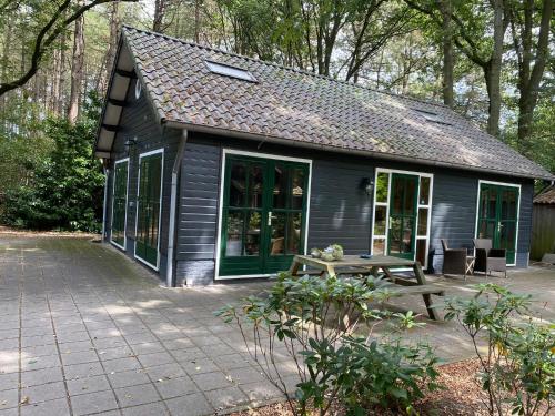 a small house with a picnic table in front of it at 't Wettenshuys in Nuenen
