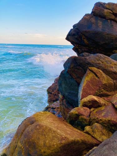 a pile of rocks next to the ocean at Manel Villa in Bentota