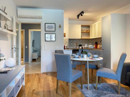 a kitchen and living room with a table and chairs at Апартамент Старецът и морето in St. St. Constantine and Helena