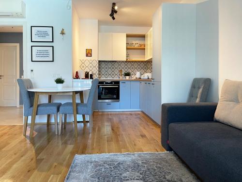 a living room and kitchen with a table and a couch at Апартамент Старецът и морето in St. St. Constantine and Helena