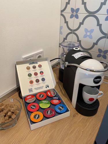 a box of cupcakes next to a coffee maker at Апартамент Старецът и морето in St. St. Constantine and Helena