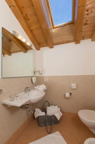 a bathroom with a sink and a toilet at Berghotel Johanneshof in Anterselva di Mezzo
