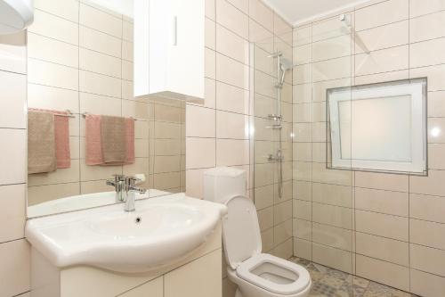 a white bathroom with a sink and a toilet at Apartment Molnar Crikvenica in Crikvenica