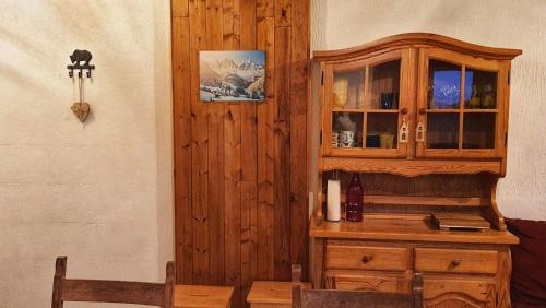 um armário de madeira num quarto com uma mesa em Le Chalet de Poche - Gite 2 étoiles - 5 pers em Habère-Poche