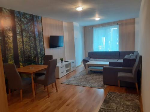 a living room with a couch and a table at Apartman" AROMA 2 "Bjelasnica in Bjelašnica