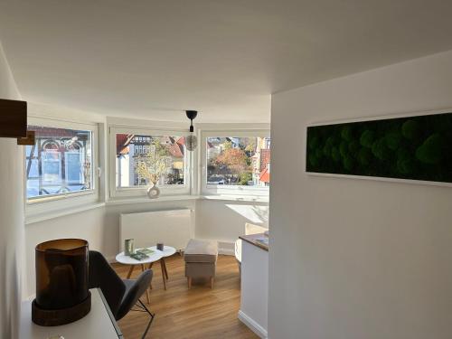 a living room with white walls and windows at TURM.blick in Goslar