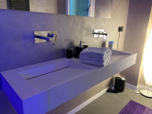 a bathroom with a white counter with a towel on it at Villa Primodì in Bologna