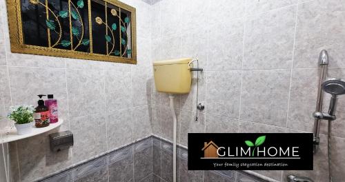 a bathroom with a yellow dispenser on the wall at Super Spacious Kuantan Homestay 4R4B by GlimHome in Kuantan