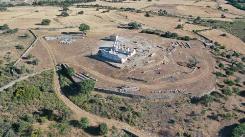 an aerial view of an old building in a field at Xerolithos Natural Living in Naxos Chora