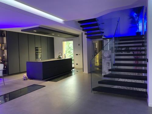 a modern staircase in a house with purple lighting at Villa Primodì in Bologna