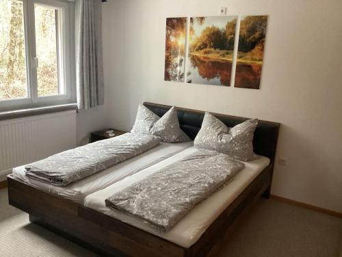 a bed in a room with two pillows on it at Schöne Ferienwohnung Nähe der Schweizer Grenze in Lauchringen