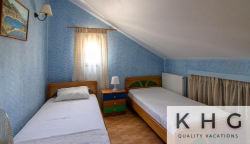 Postel nebo postele na pokoji v ubytování Villa Harmony in Lourdata