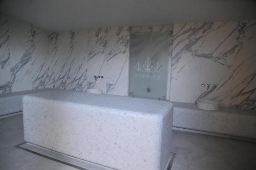 a marble bathroom with a white counter in a room at Family Apart Woodside in Kopaonik