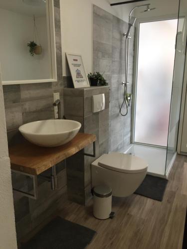 a bathroom with a sink and a toilet at Quinta da Layla in Olhão