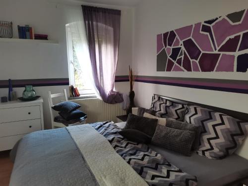 a bedroom with a bed and a chair and a window at Auszeit in Freital
