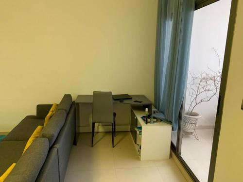 a living room with a couch and a table at AYA Mermoz - Superbe appartement dans une résidence récente in Dakar