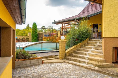 a house with a staircase leading to a swimming pool at Luxusní vila v Rudici in Rudice