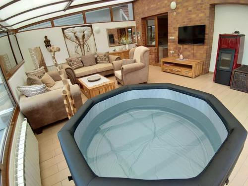 a living room with a large tub in the middle at Luxusní vila v Rudici in Rudice