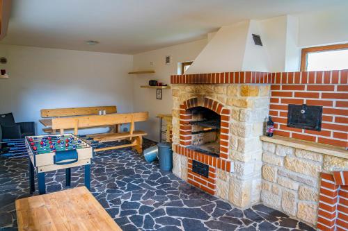 a living room with a brick fireplace and a table at Luxusní vila v Rudici in Rudice