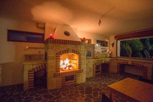 a living room with a brick fireplace in a kitchen at Luxusní vila v Rudici in Rudice