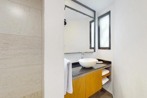 a bathroom with a sink and a mirror at Seven Boutique 10 in Cancún
