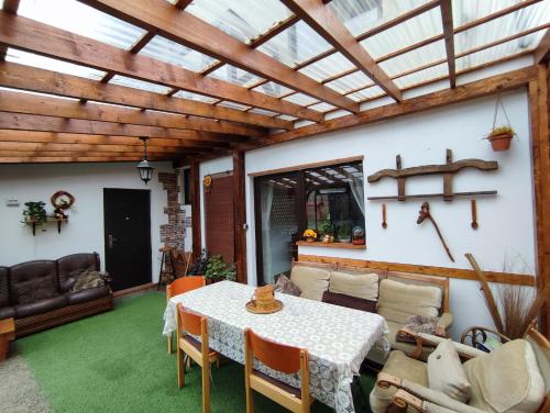 a living room with a table and a couch at Bucovina Sky View in Gura Humorului