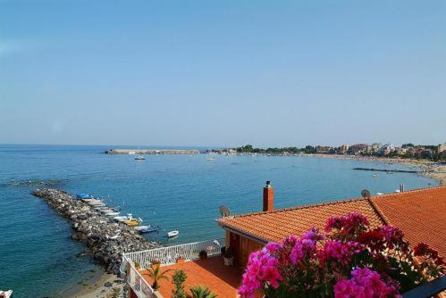 
a view from a balcony overlooking the ocean at Costa Azzurra in Giardini Naxos
