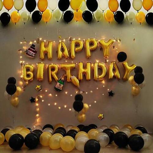 a black and gold birthday cake with a happy birthday sign at Large Family Seaview Suite 3 Rooms by The Only Bnb in Tanjong Tokong