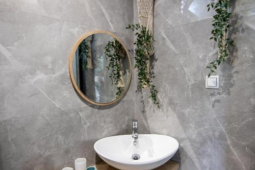 a bathroom with a sink and a mirror at Georgianna's suite with private pool , 'blank suite' in Kharokopión