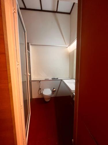 a small bathroom with a toilet and a sink at Nexstay Colony Artotel, Fort Kochi in Cochin