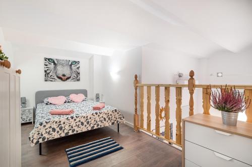 a bedroom with a bed with pink pillows on it at Magic Badalona Apartment in Badalona