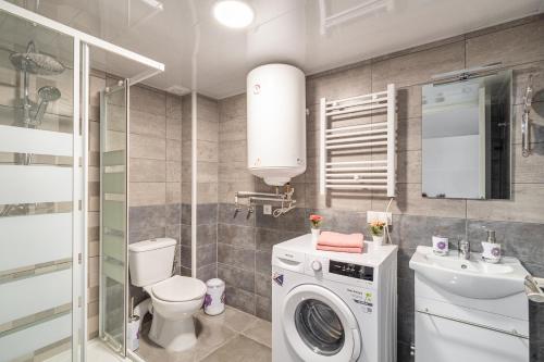 a bathroom with a washing machine and a sink at Magic Badalona Apartment in Badalona