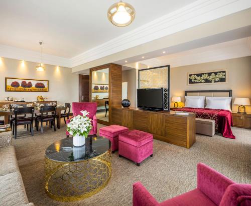 a hotel room with a bed and a living room at Hotel Çelik Palas Convention Center & Thermal SPA in Bursa