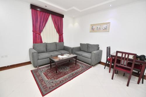 a living room with two couches and a table at Aseel Alsharq Serviced Apartments - اقتصادي in Riyadh