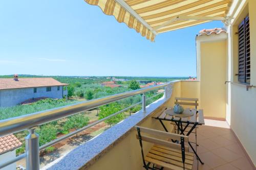 a balcony with a table and chairs and a view at Apartments Belvedere in Plovanija