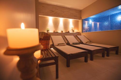 a row of benches in a room with a candle at Fusion Hplus Express + in Brasilia
