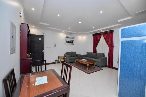 a living room with a couch and a table at Aseel Alsharq Serviced Apartments - اقتصادي in Riyadh