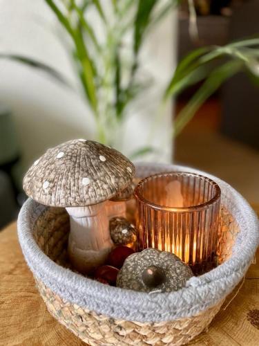 a bowl with a mushroom and a candle on a table at Mya Lenas Suite in Irrel