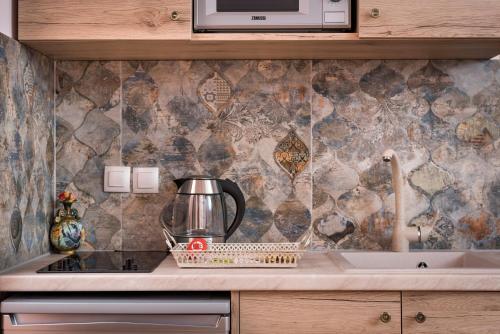 a kitchen with a counter top with a microwave at Palazzo di Irene in Chania Town
