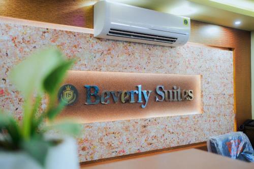 a sign for aneyasy smiles on a wall at BEVERLY SUITES in Wayanad