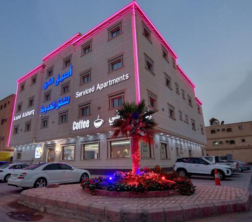 a building with a palm tree in front of it at Aseel Alsharq Serviced Apartments - اقتصادي in Riyadh