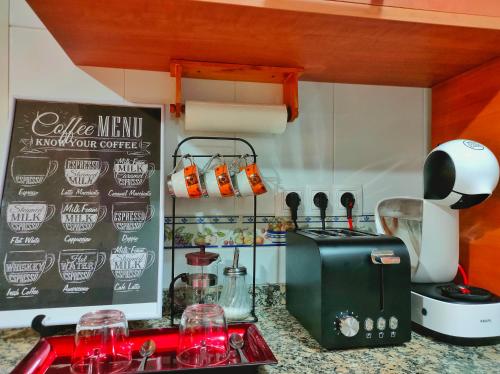 a kitchen with a counter top with a coffee maker at A Casiña do Patio in Quiroga