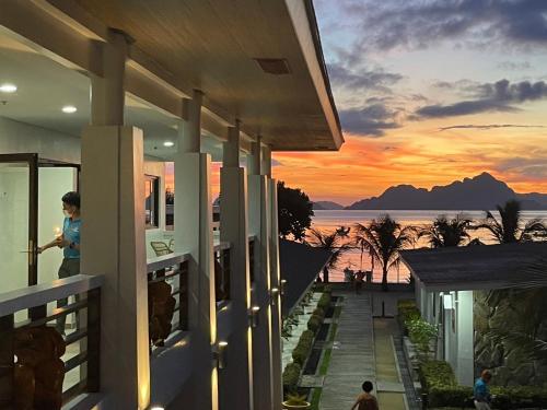 a house with a view of the ocean at sunset at El Nido Greenwoods in El Nido