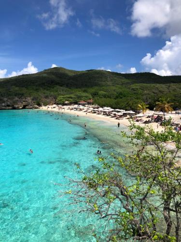 a beach with a bunch of people in the water at Boca Simon Vacation Curacao in Willemstad