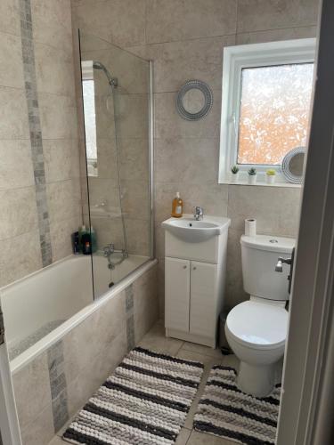 a bathroom with a toilet and a sink and a shower at Beresford ground floor Seafront apartment in Southend-on-Sea