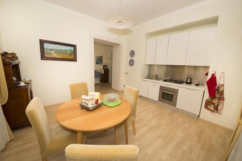 a kitchen and dining room with a table and chairs at BREZZA DEL CONERO in Ancona