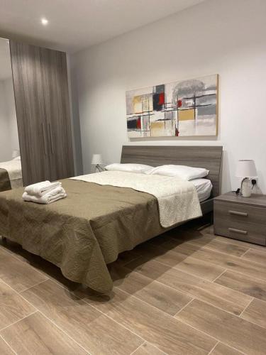 a bedroom with a large bed and a wooden floor at Sliema Living in Sliema
