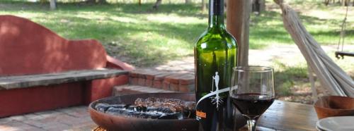 a bottle of wine sitting on a table with a glass at Finca La Encantada in San Rafael