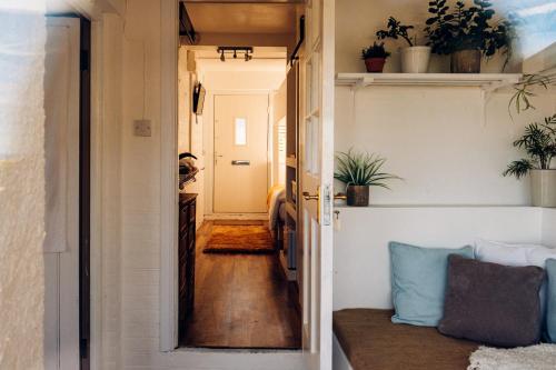 a tiny house with a hallway leading into a room at Bijou Annexe, Sea View, Private Entrance & Parking - FOLKESTONE in Folkestone