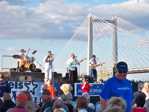 a band playing on a stage in front of a crowd at Clover Island Inn in Kennewick